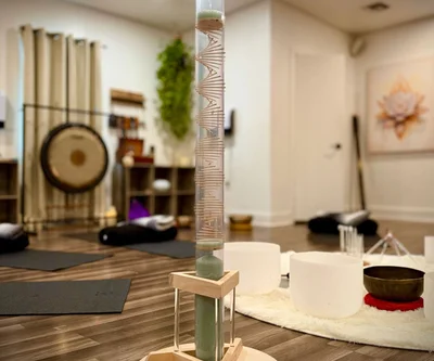 woman in black tank top lying on red textile