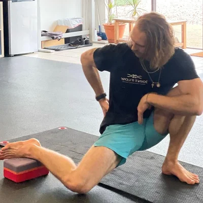 man placing weight plate on barbell
