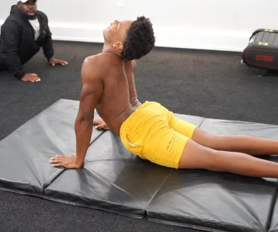 gymnas jumping near the white board