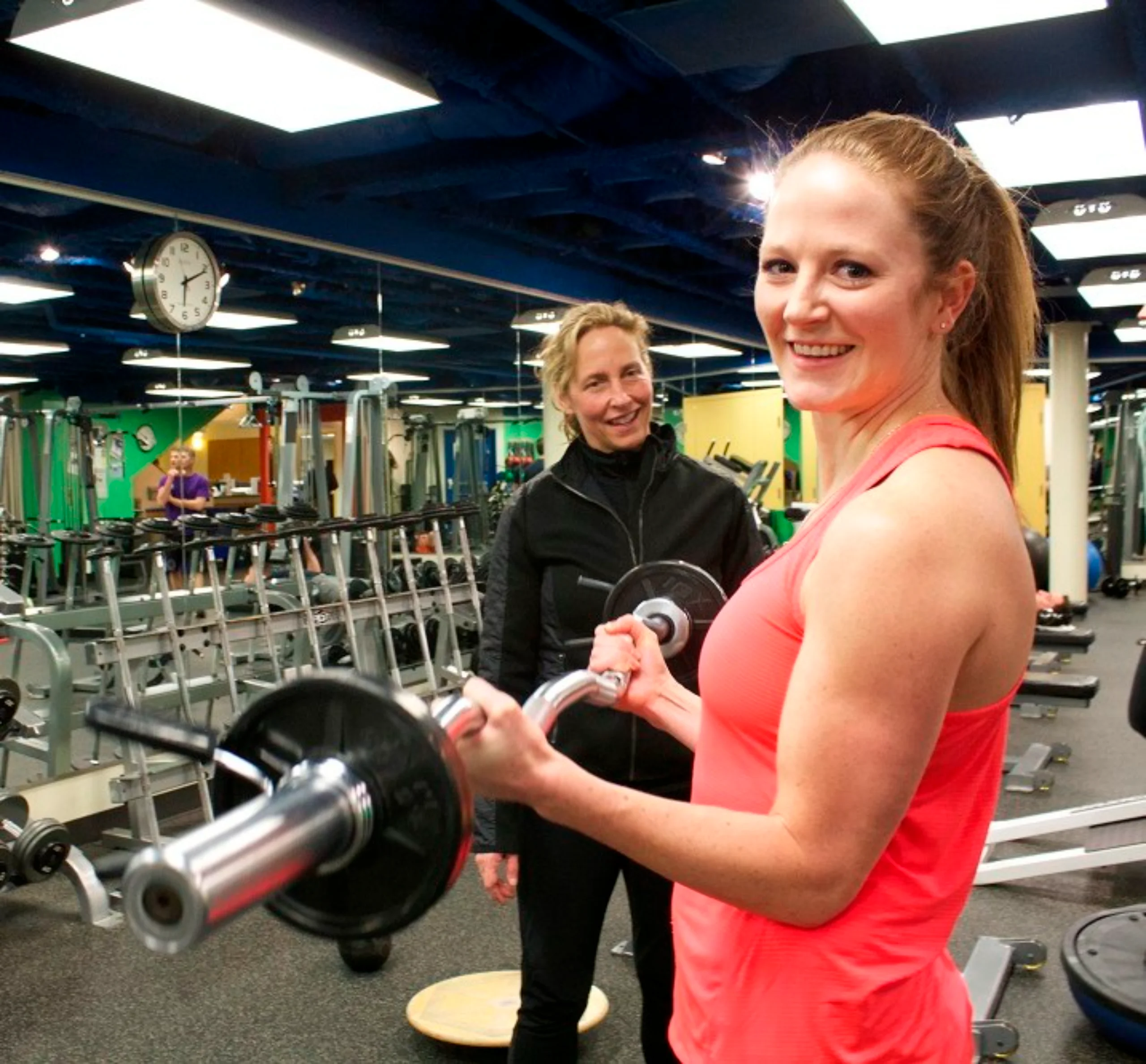 a gym with a barbell and weight plates