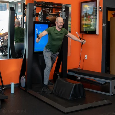 man placing weight plate on barbell